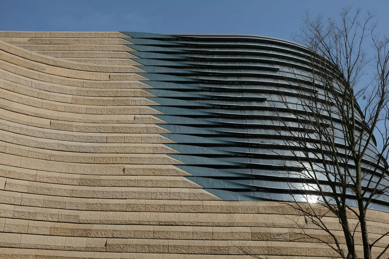 Curved stone and glass architecture, illustrative of real assets